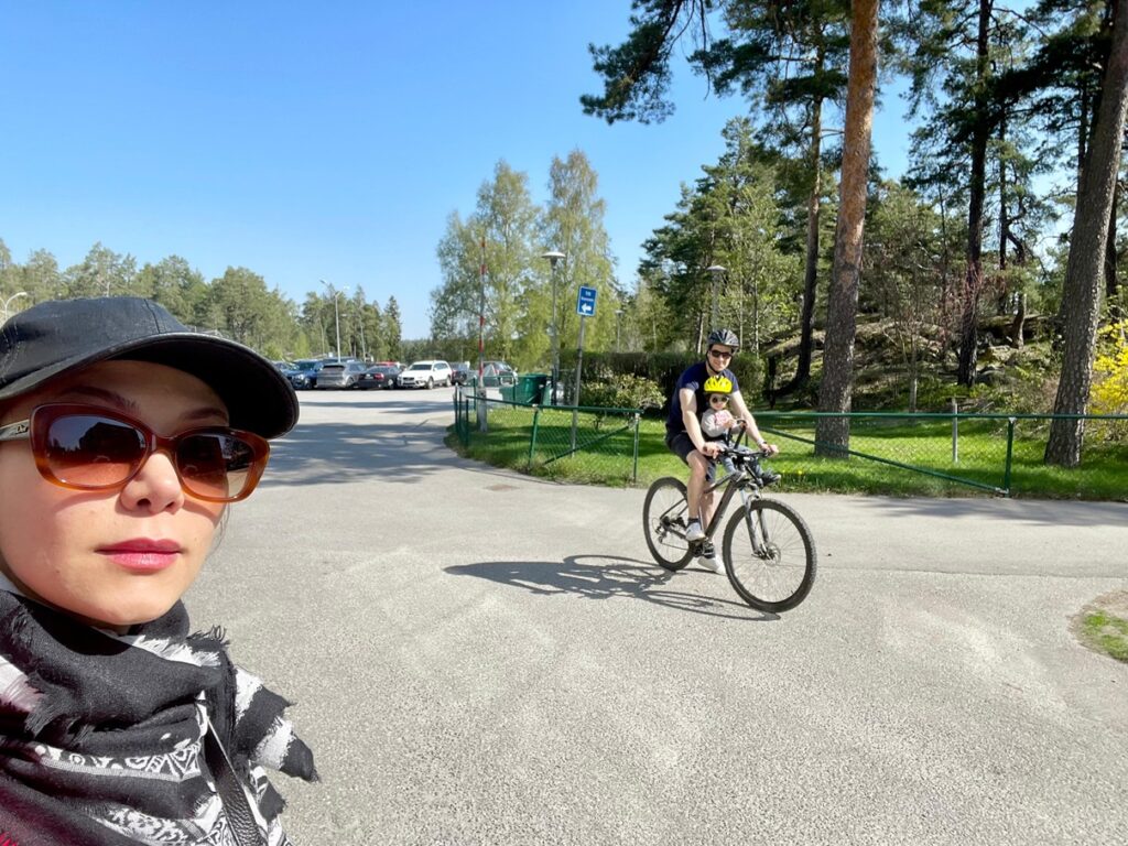 Family of three cycling together, reflecting the decision to have one child and the realities of family size.
